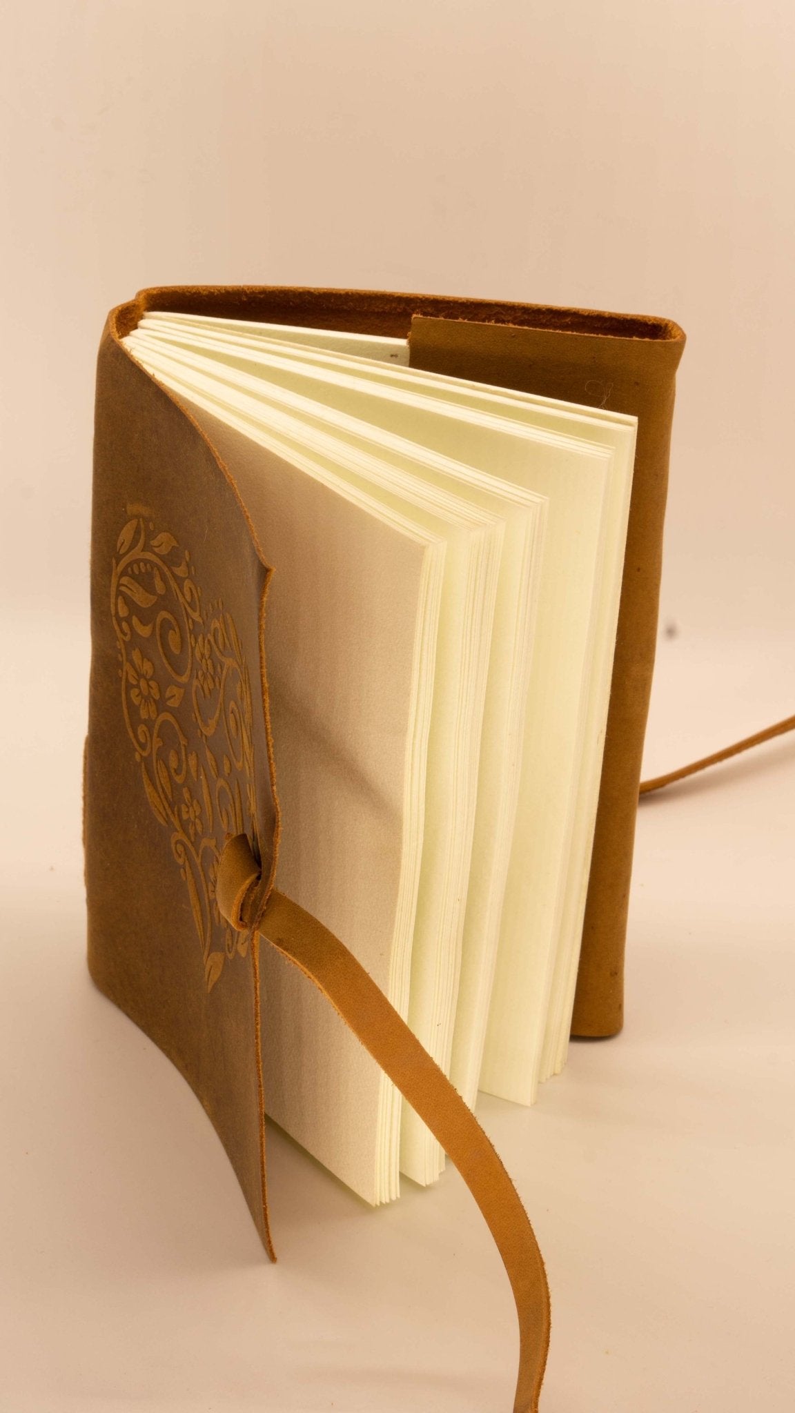 
                  
                    Leather adventurers journal embossed with a heart and with plain white paper
                  
                